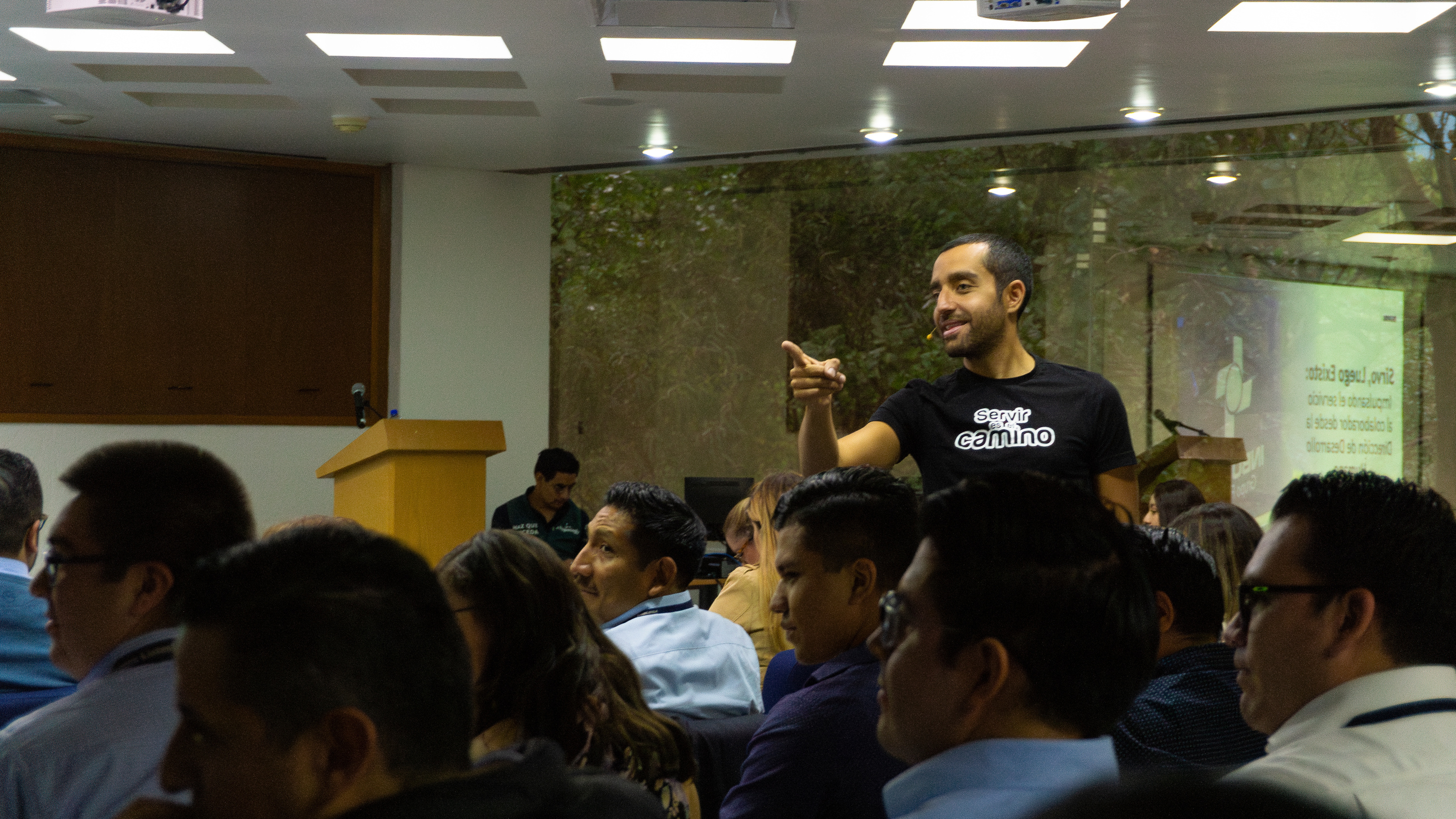 Carlos Agami interacting with attendees at a seminar